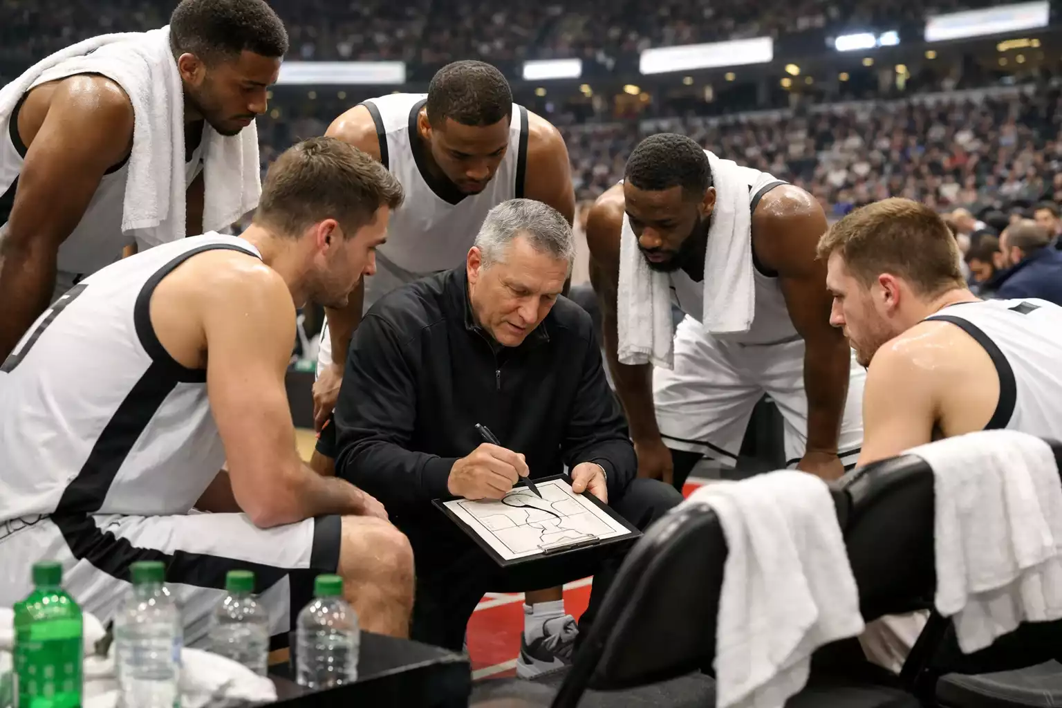 NBA team huddle on sideline during timeout discussing strategy
